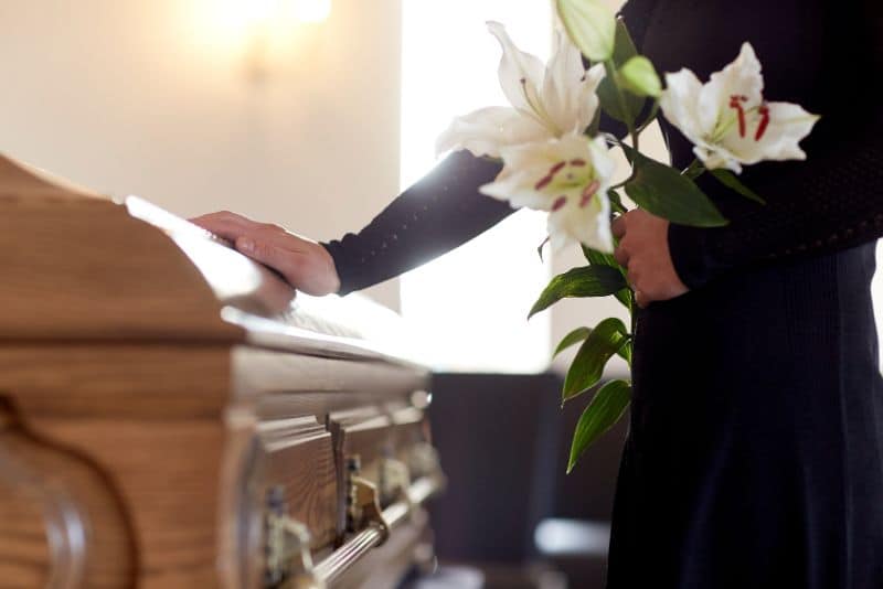 Man with casket at a funeral home.
